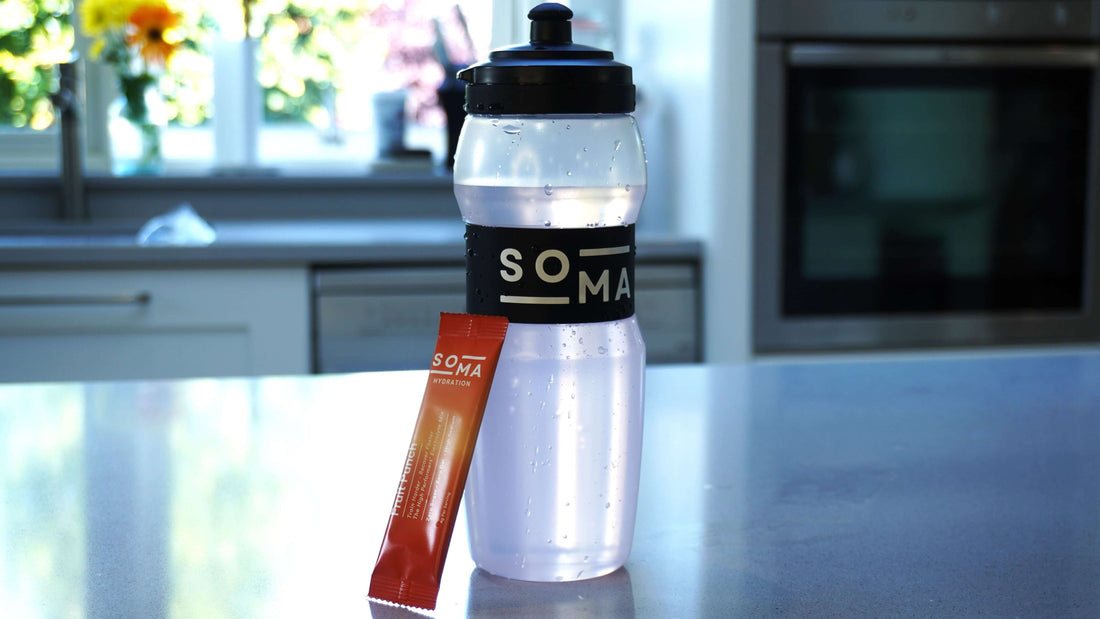 SOMA bottle and electrolyte sachet displayed in a modern white kitchen, captured in a high-quality, premium shot.