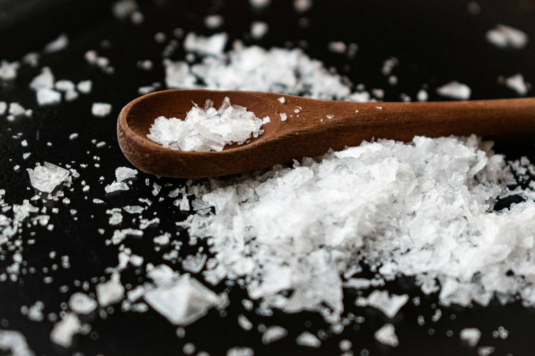 Close-up of salt crystals on a black background, emphasizing the key ingredient in SOMA electrolytes.